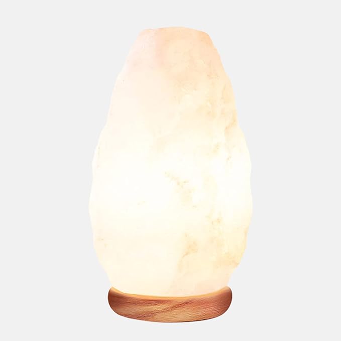 A light beige, smooth, teardrop-shaped salt lamp on a light brown wooden base.