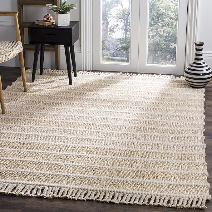 Beige rug with white stripes and fringe. A black nightstand and chair are visible.